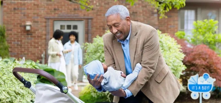 Image of a grandfather placing a baby in a carriage, as a grandmother and mother talk in the background (not actual patients) mobile