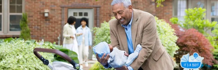 Image of a grandfather placing a baby in a carriage, as a grandmother and mother talk in the background (not actual patients)