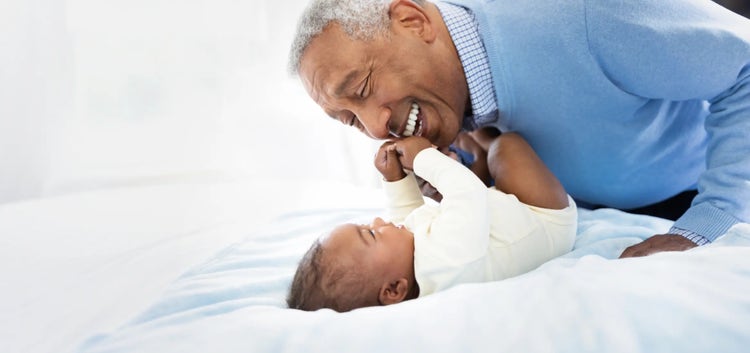 Image of grandfather playing with a baby (not actual patients)