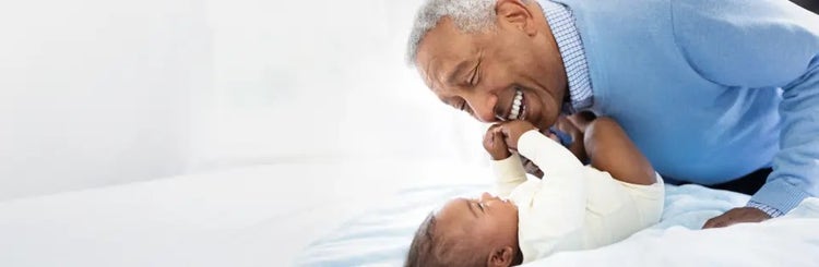 Image of grandfather playing with a baby (not actual patients)