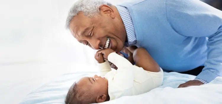 Image of grandfather playing with a baby (not actual patients) mobile